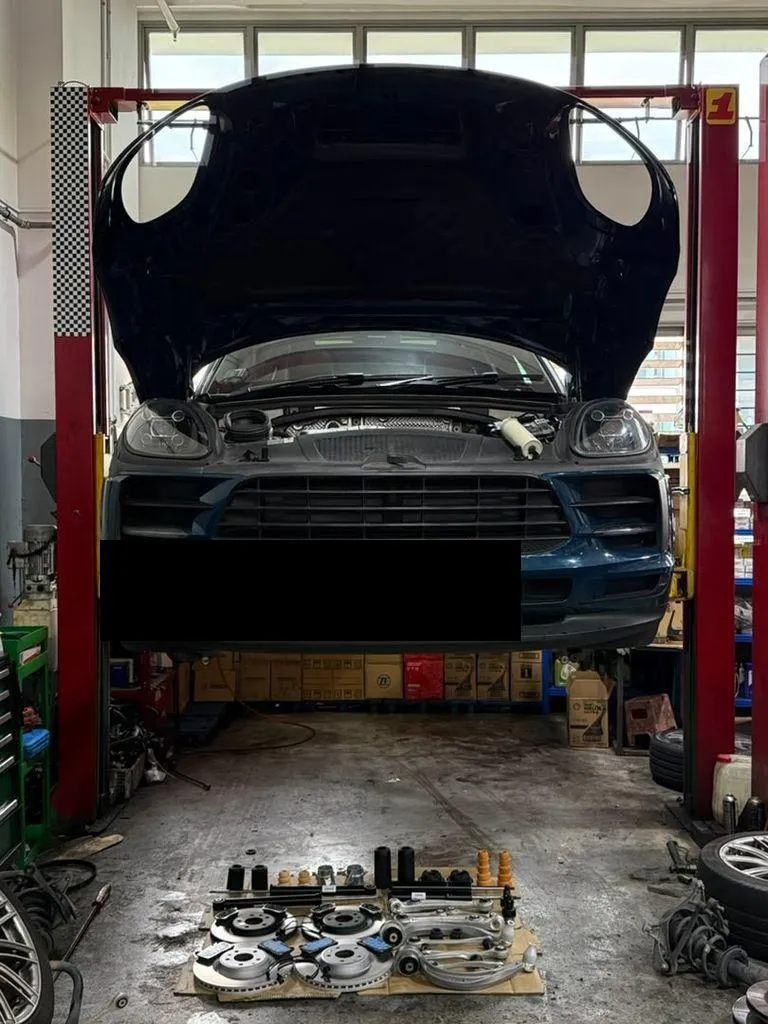Porsche Macan raised on the workshop lift for a full suspension inspection