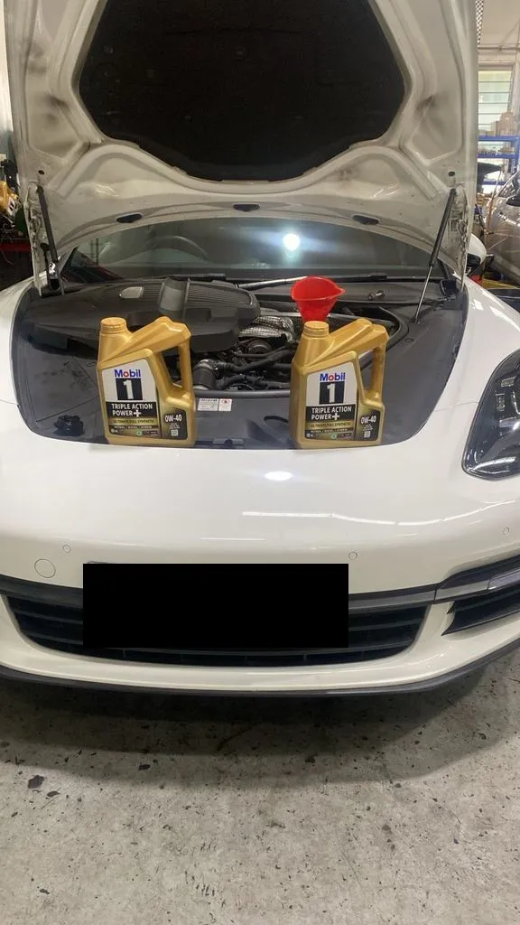 White Porsche Panamera with the bonnet up at our Singapore workshop for an aircon repair and major service