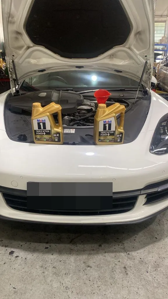 White Porsche Panamera with the bonnet up at our Singapore workshop for an aircon repair and major service