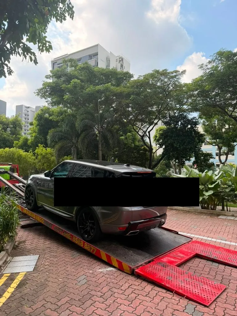 Range Rover Sport PHEV being towed after air suspension collapse, arriving at our Singapore workshop