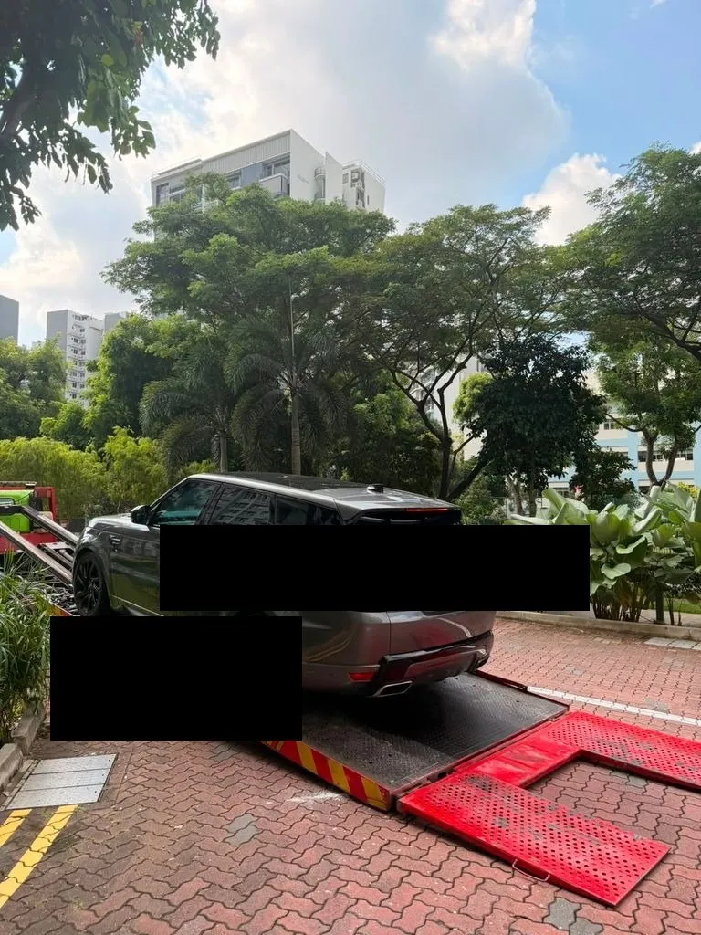 Range Rover Sport PHEV being towed after air suspension collapse, arriving at our Singapore workshop