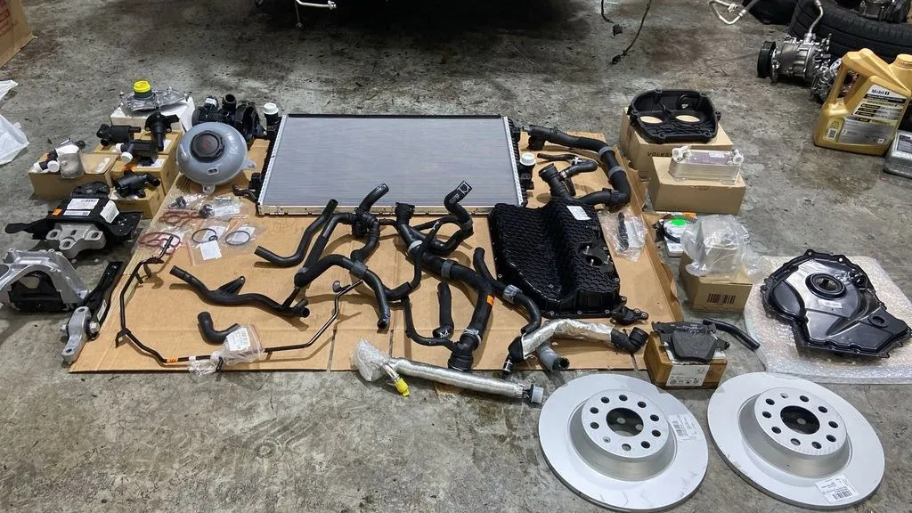 All Skoda Octavia cooling system and brake parts removed and laid out for replacement at 1 Car Service Singapore