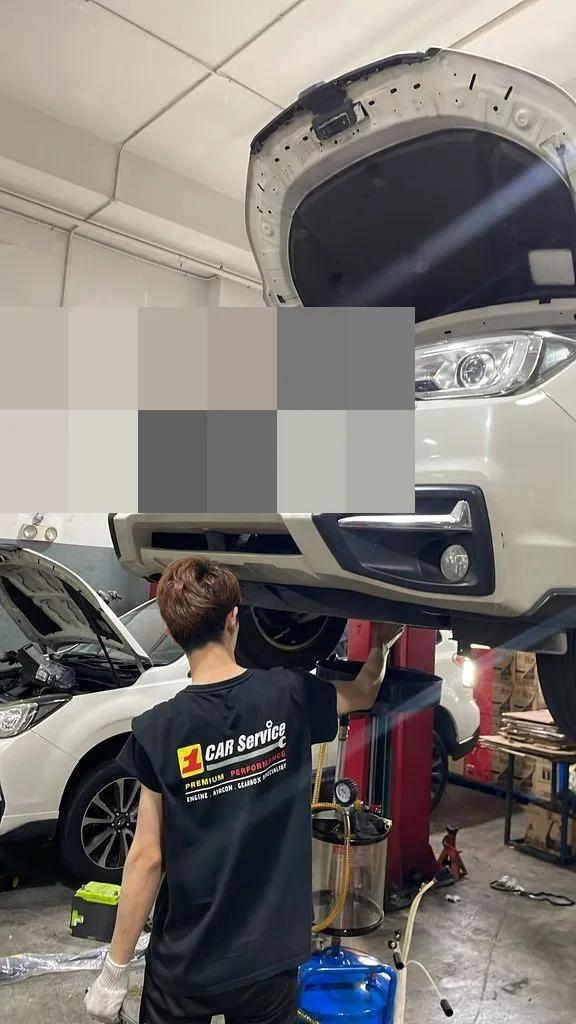Subaru Forester raised on a lift at our Singapore workshop