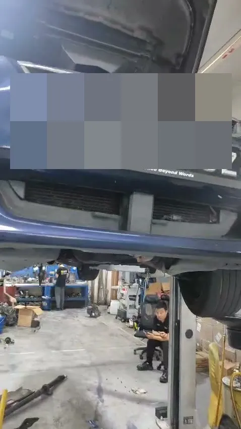 Subaru on the workshop lift with bonnet open during automatic gearbox overhaul at 1 Car Service Singapore