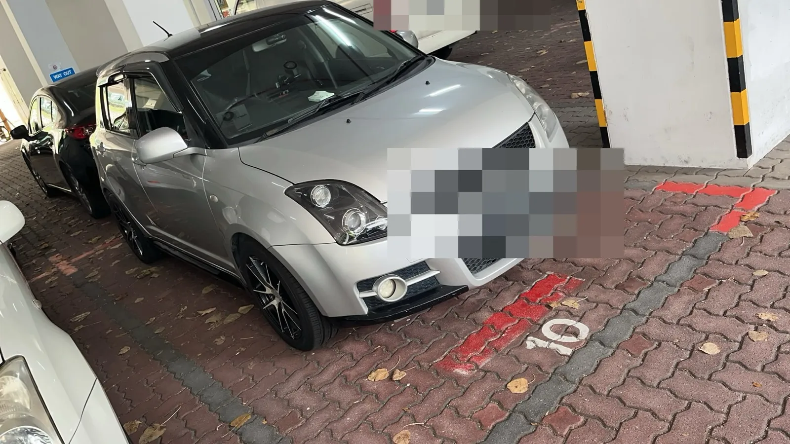 Suzuki Swift parked indoors