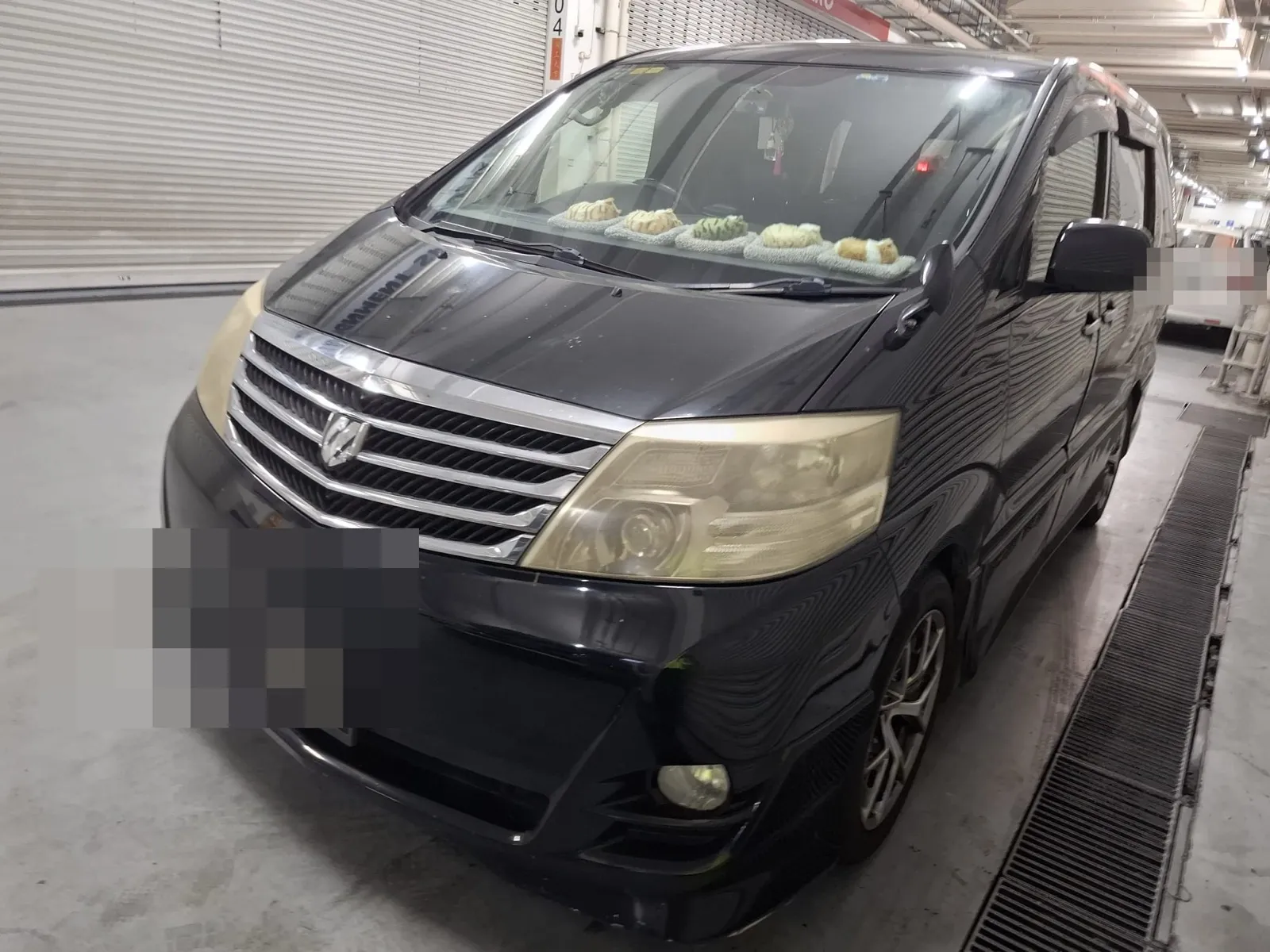 Toyota Alphard parked in a workshop bay ahead of servicing