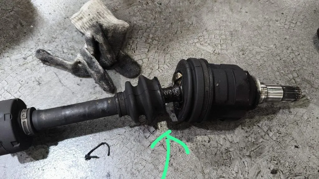 Torn CV joint boot on a Toyota Corolla Altis front driveshaft found during inspection in Singapore
