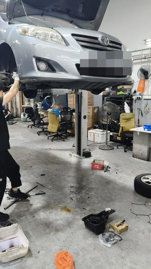 Silver Toyota Corolla Altis on the lift at our Singapore workshop for a gearbox overhaul