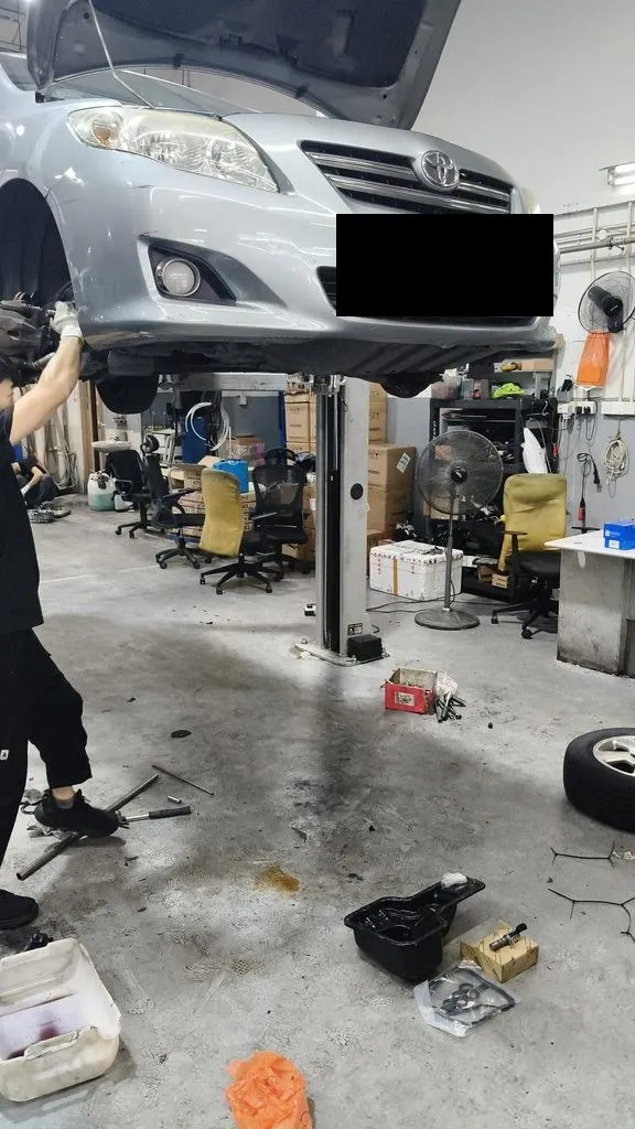Silver Toyota Corolla Altis on the lift at our Singapore workshop for a gearbox overhaul