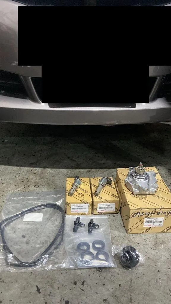 Toyota genuine VVT-i oil control valves and vacuum pump parts before installation at 1 Car Service Singapore workshop