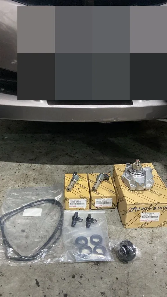 Toyota genuine VVT-i oil control valves and vacuum pump parts before installation at 1 Car Service Singapore workshop