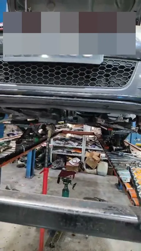 VW Golf GTI on the hoist at our Singapore workshop for a manual gearbox overhaul, red GTI grille trim strip visible
