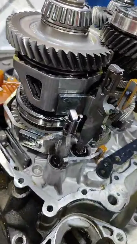 Stripped VW Golf GTI manual gearbox on the bench showing gear clusters, selector forks and internal components during the overhaul at our Singapore workshop
