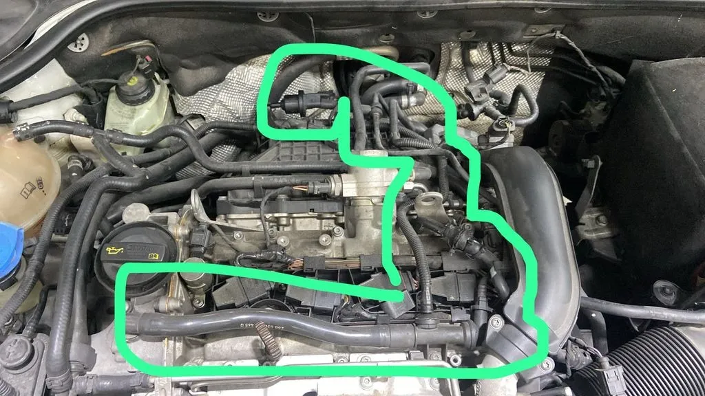 Volkswagen Jetta engine bay with the advised air pipes circled in green
