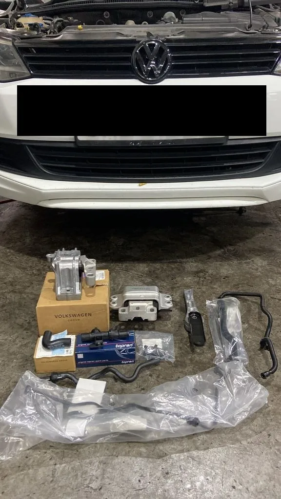 New engine mounts and air pipes laid out in front of a Volkswagen Jetta at our Singapore workshop