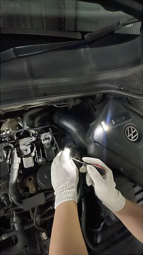 Our technician working on the engine bay of a VW Passat at our Singapore workshop