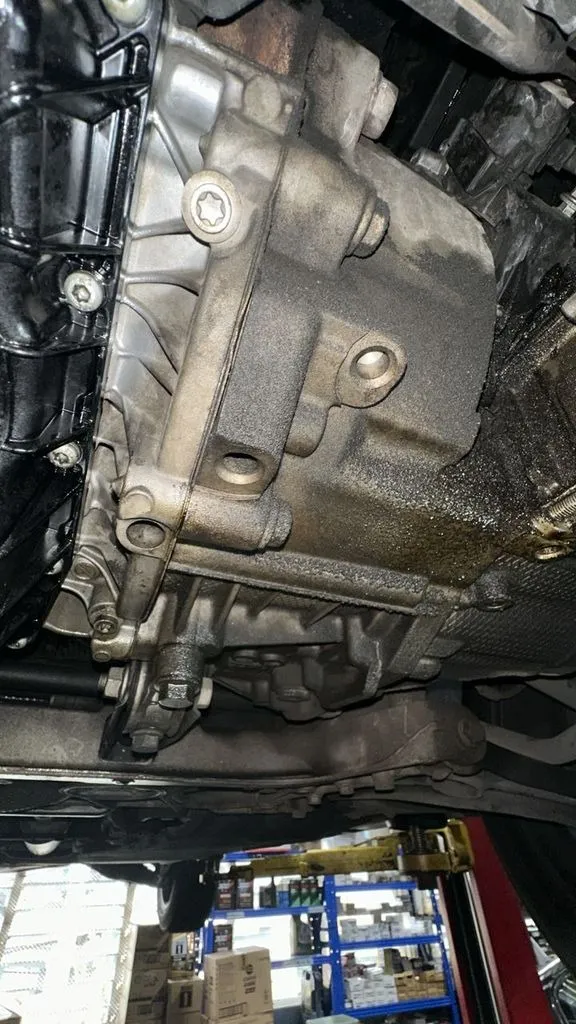 DSG mechatronic unit removed from a VW Passat showing a visible oil leak, at our Singapore workshop