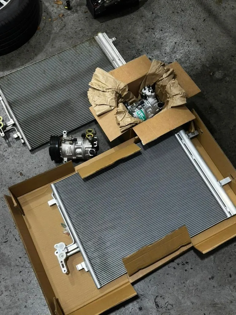 New Volvo V40 aircon compressor and condenser parts laid out before fitting at 1 Car Service Singapore