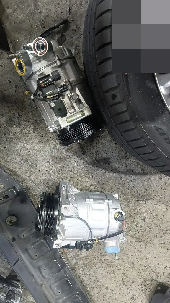 Old and new aircon compressors for a Volvo V70 at our Singapore workshop