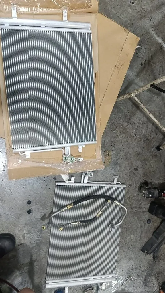 Old and new aircon condensers for a Volvo V70 during an aircon repair in Singapore