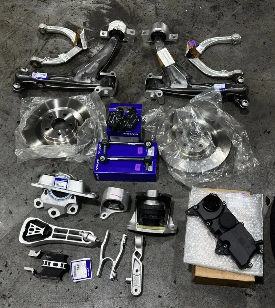 All new Volvo OEM suspension arms, brake discs, brake pads and engine mounts laid out before fitting to the Volvo XC90