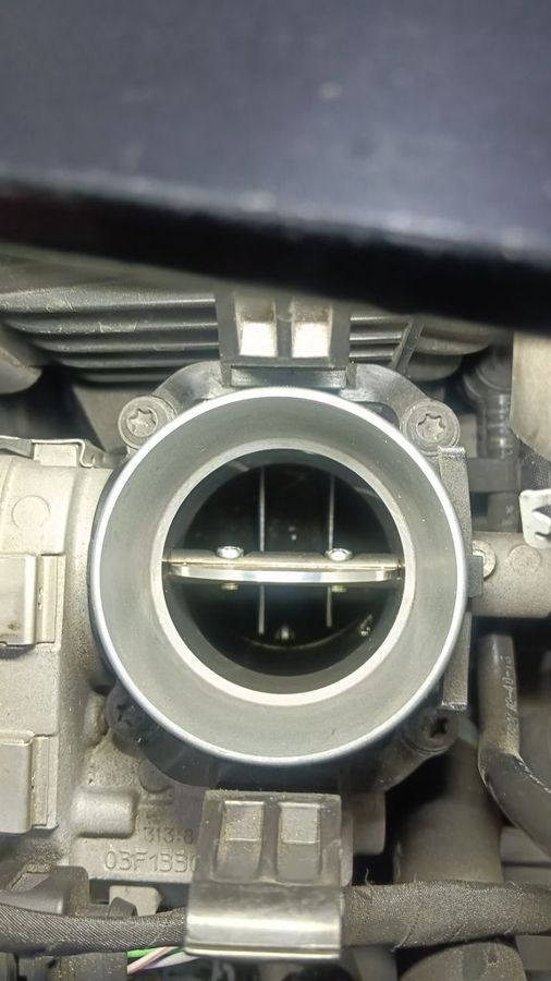 Kia Sportage throttle body after cleaning, showing the butterfly plate and bore clear of carbon buildup