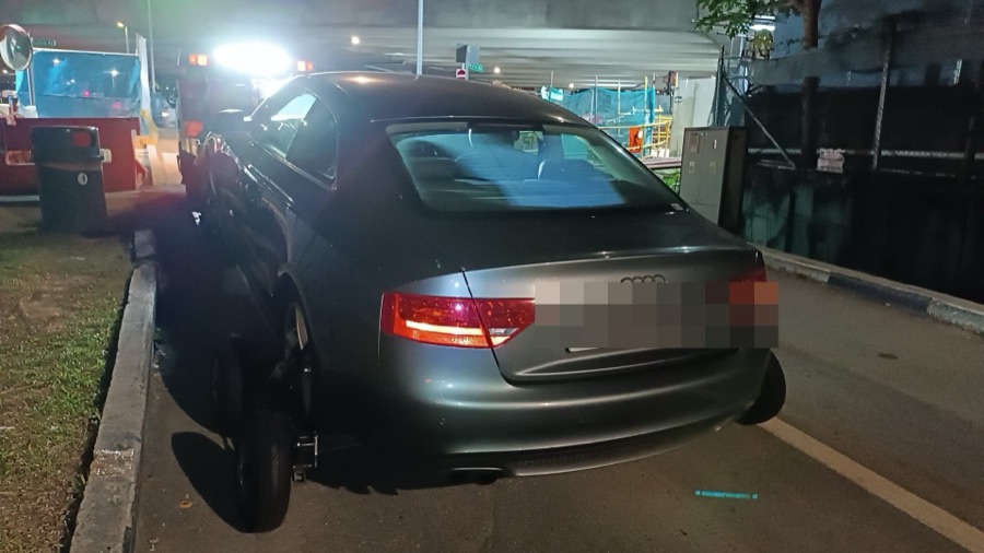 Audi A5 being towed in for workshop service at night