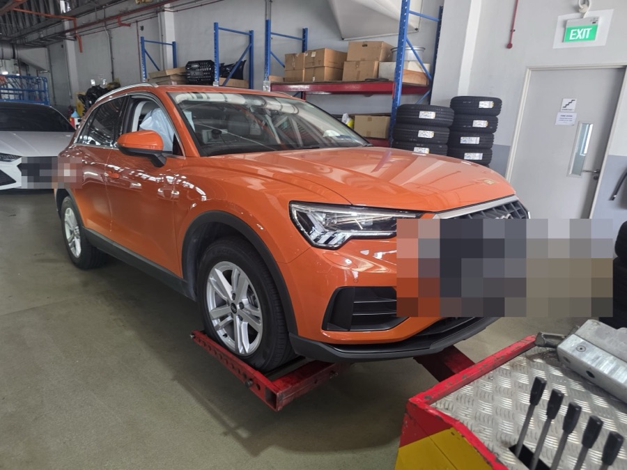 Audi Q3 SUV parked indoors, front view