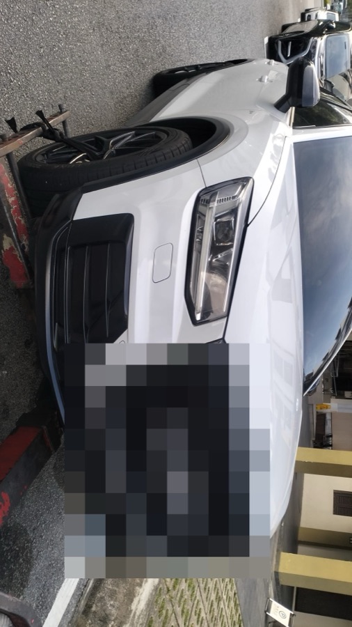 Audi Q3 being transported by flatbed tow truck