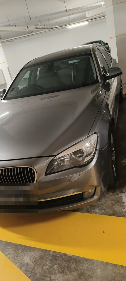 BMW 7 Series sedan parked indoors, front view