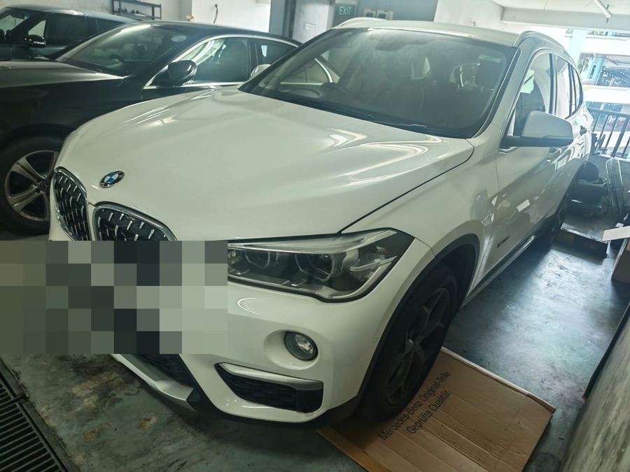 White BMW X1 SUV parked at our Singapore workshop