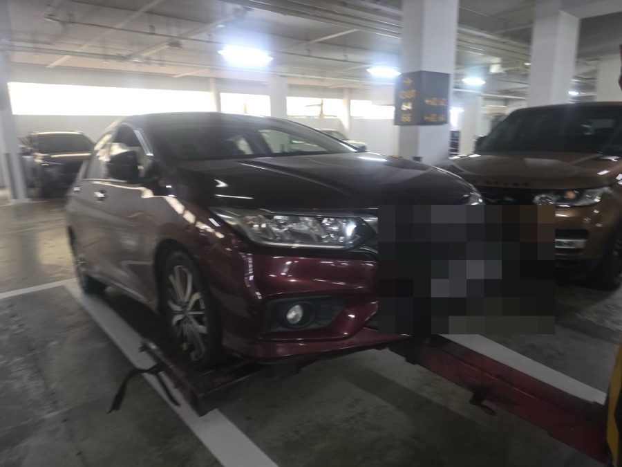 Honda City sedan parked indoors, front view