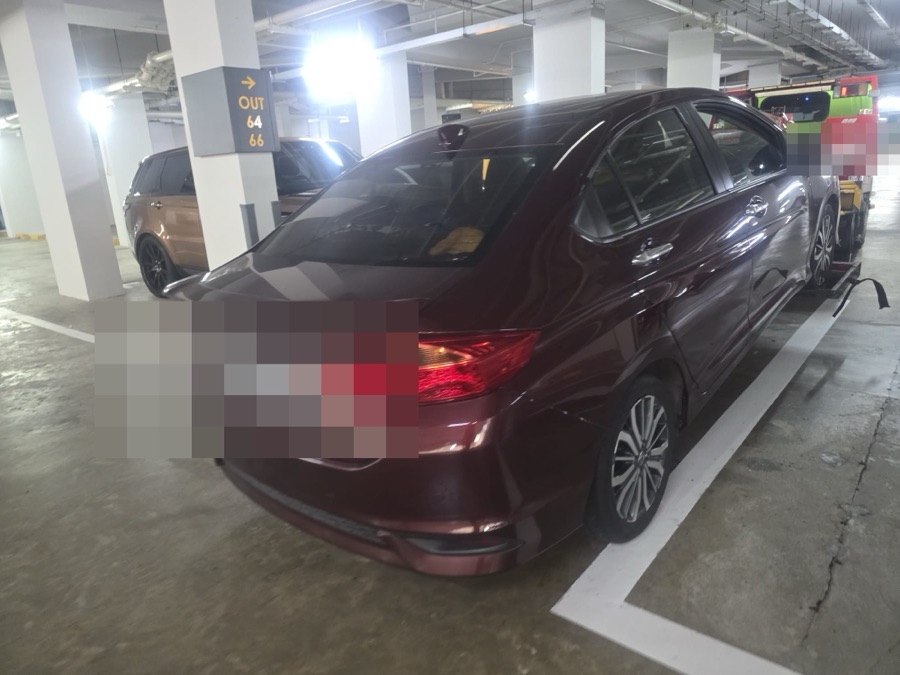 Honda City sedan parked indoors, rear view