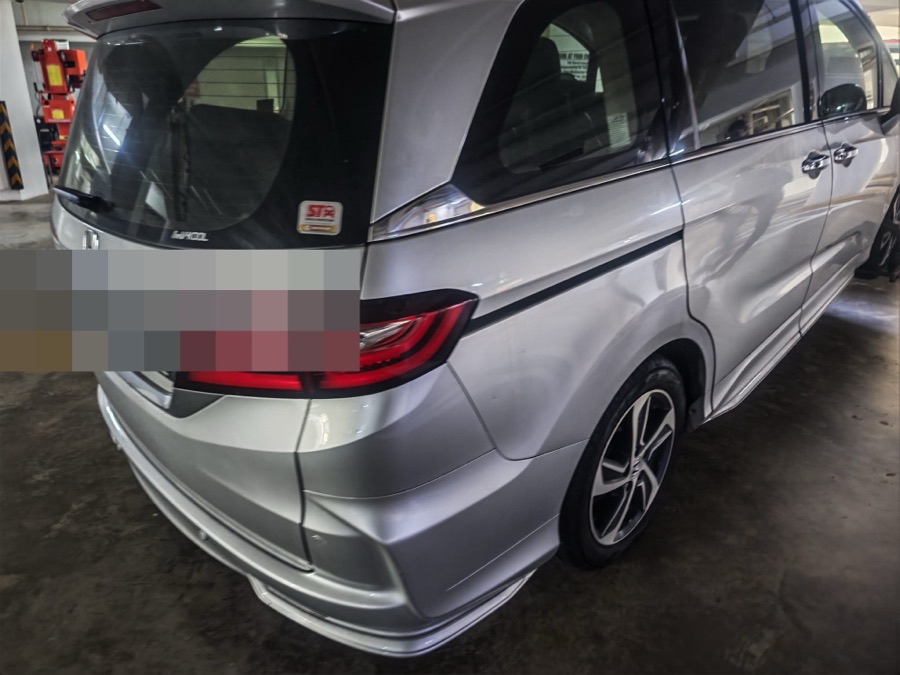 Honda Odyssey MPV parked indoors, rear view