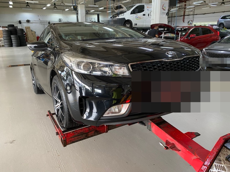 Black Kia Cerato sedan at our Singapore workshop