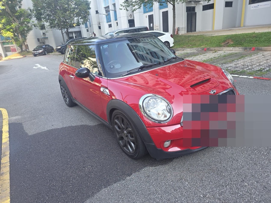 MINI Cooper hatchback in red with a black roof, front view, parked outdoors