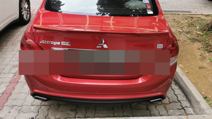 Mitsubishi Attrage parked roadside before pickup for repair.