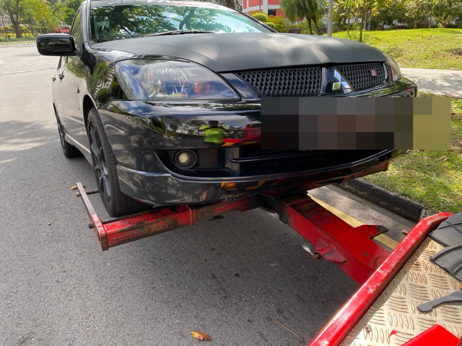 Mitsubishi Lancer arriving by tow at our Singapore workshop