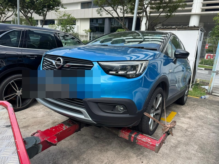Blue Opel Crossland X SUV being towed to our Singapore workshop