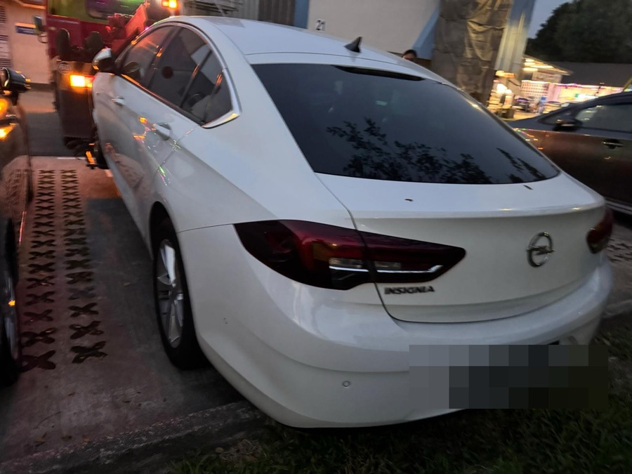 Opel Insignia being towed in for repair at our Singapore workshop.