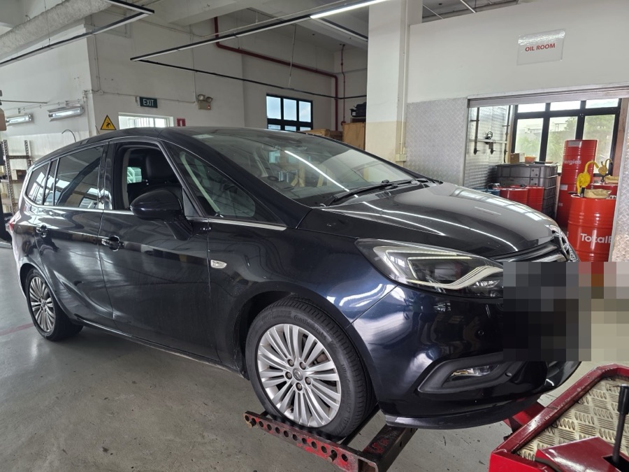 Dark blue Opel Zafira Tourer MPV being moved at our Singapore workshop