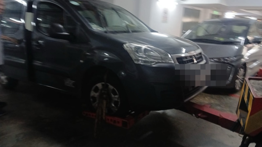 Peugeot Partner on a tow dolly, ready for transport.