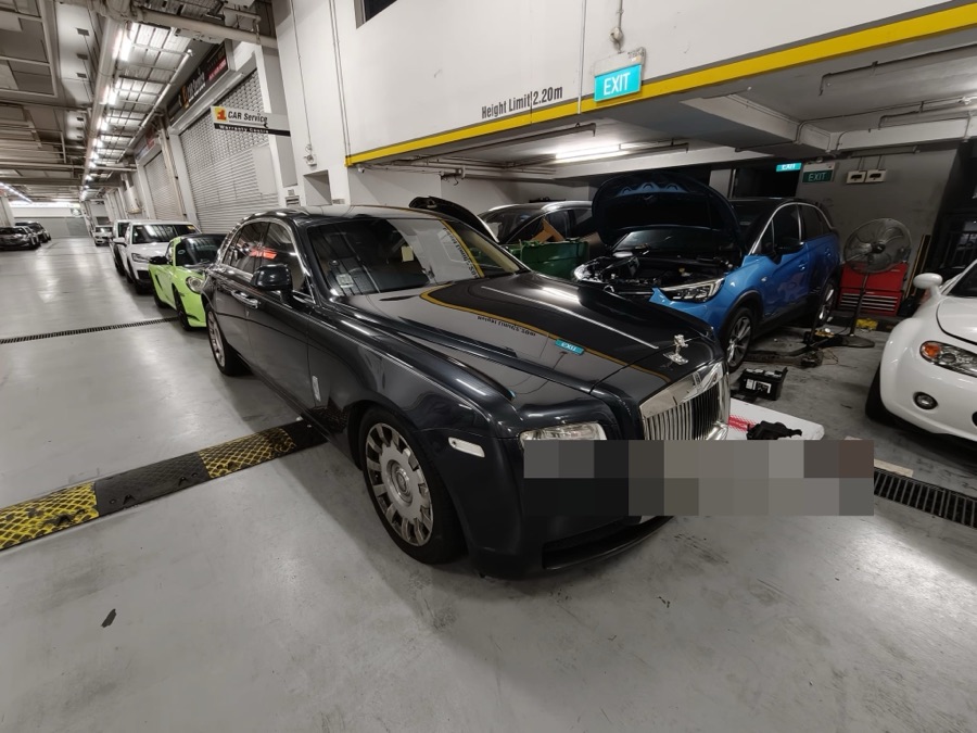 Dark blue Rolls-Royce Ghost sedan at our Singapore workshop
