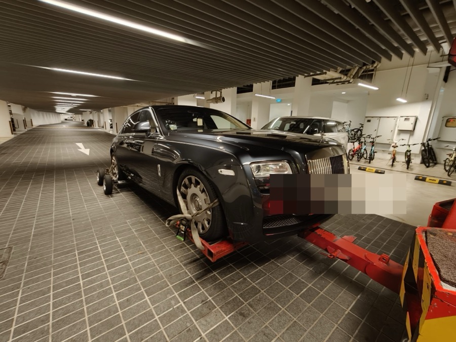 Dark blue Rolls-Royce Ghost sedan being towed to our Singapore workshop