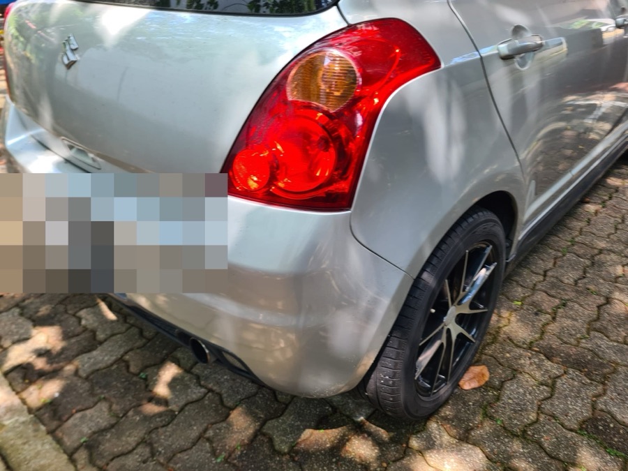 Suzuki Swift hatchback with a sports bodykit, parked outdoors