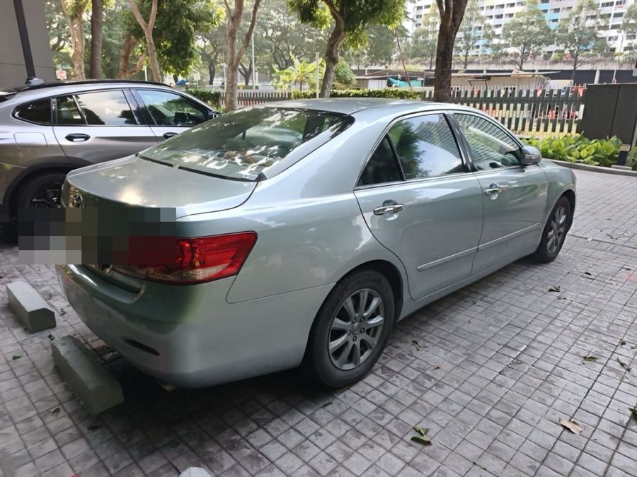 Toyota Camry sedan parked outdoors, rear view