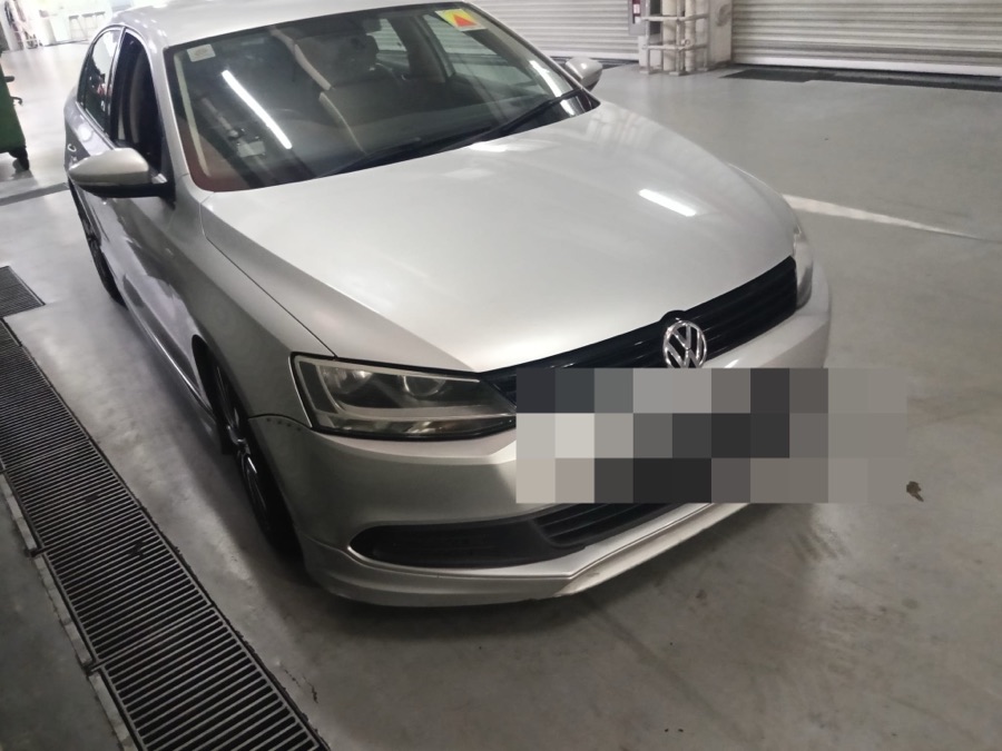 Volkswagen Jetta parked in a workshop garage, front view